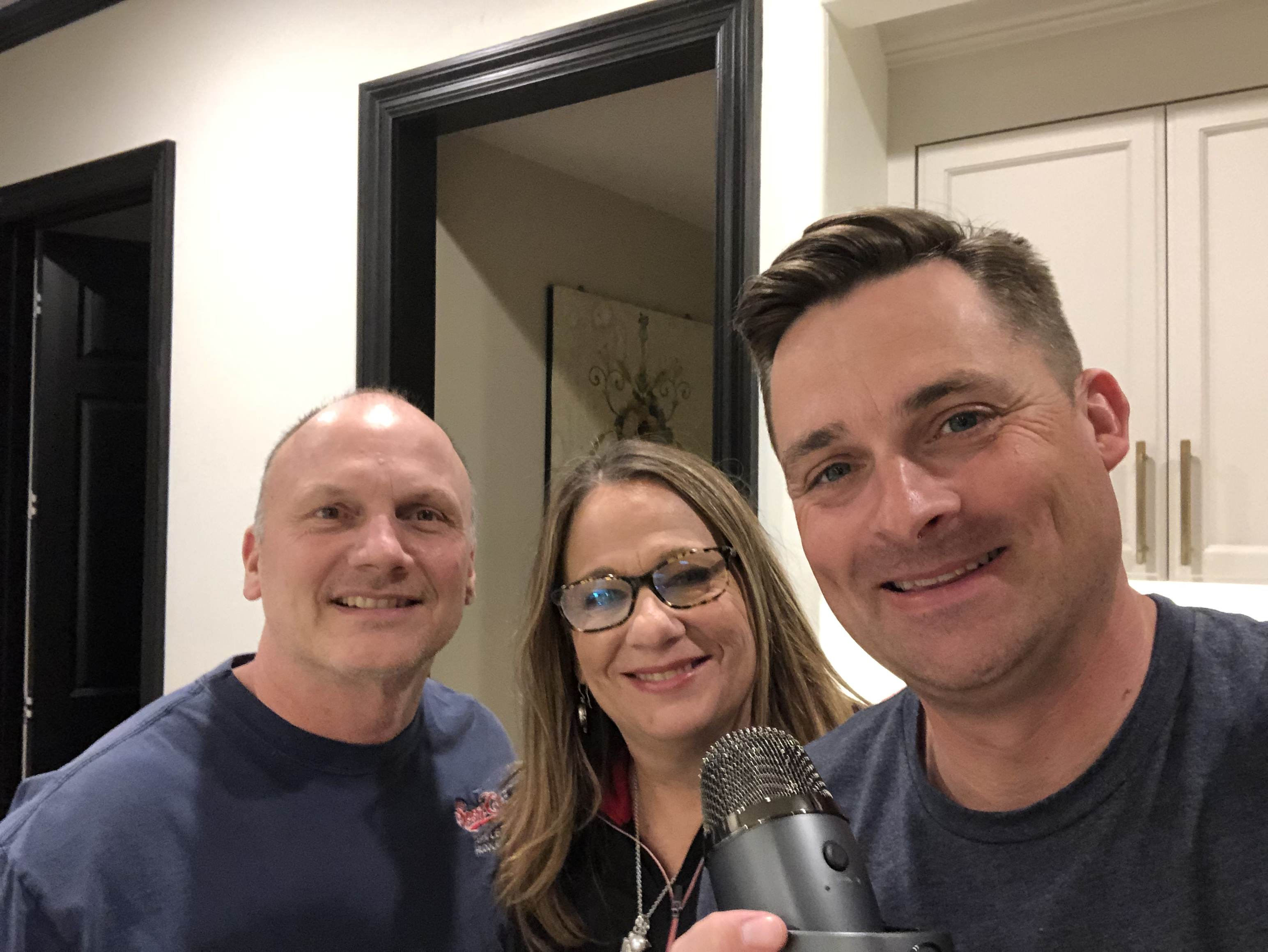 Chad Jordan, Jan Mansfield Mark Mansfield holding a microphone